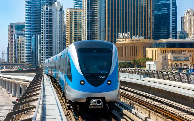 BurJuman Metro Station Dubai Metro train on elevated tracks with modern city skyline and Dubai transport network