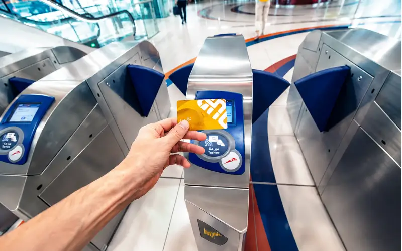 BurJuman Metro Station Nol Card payment gate showing passenger tapping travel card at Dubai Metro entrance