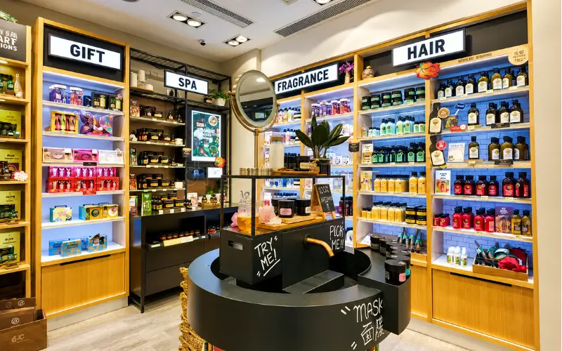 Al Khail Gate Community Centre personal care products section featuring hair care, fragrance, spa essentials, and gift items displayed on organized shelves in a bright modern retail store.